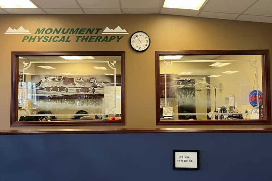 View of North Platte Physical Therapy reception area with windows and clock.