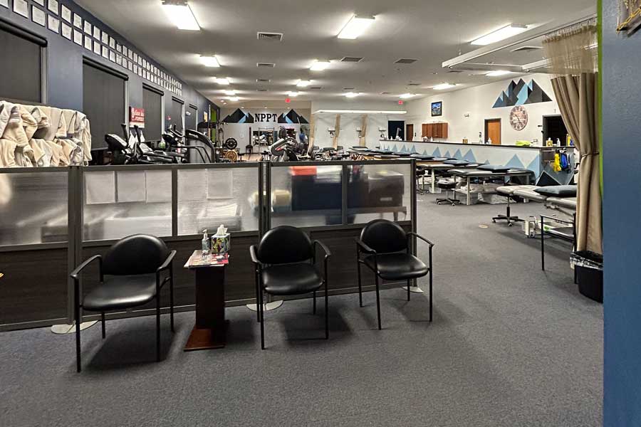 Interior view of North Platte Physical Therapy with treatment tables and seating area.
