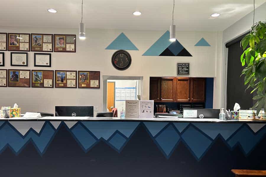 Reception area at North Platte Physical Therapy with wall decor and a front desk.