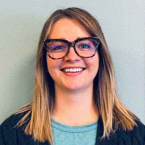 Smiling woman with glasses at North Platte Physical Therapy clinic.