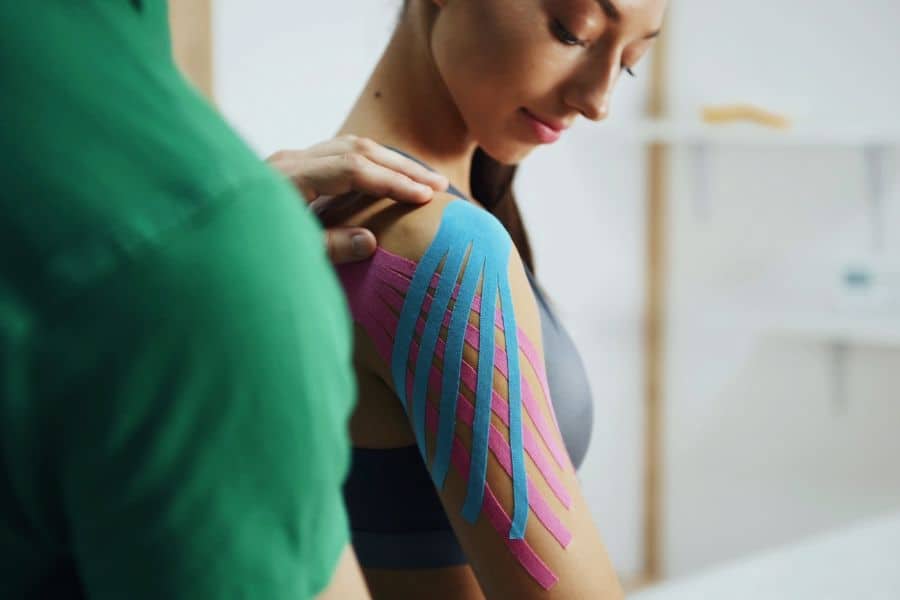 Woman receiving kinesiology taping therapy on shoulder at North Platte PT.