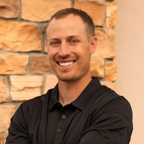 Smiling physical therapist in black shirt at North Platte PT clinic.
