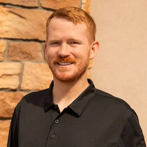 Friendly physical therapist smiling at North Platte clinic.