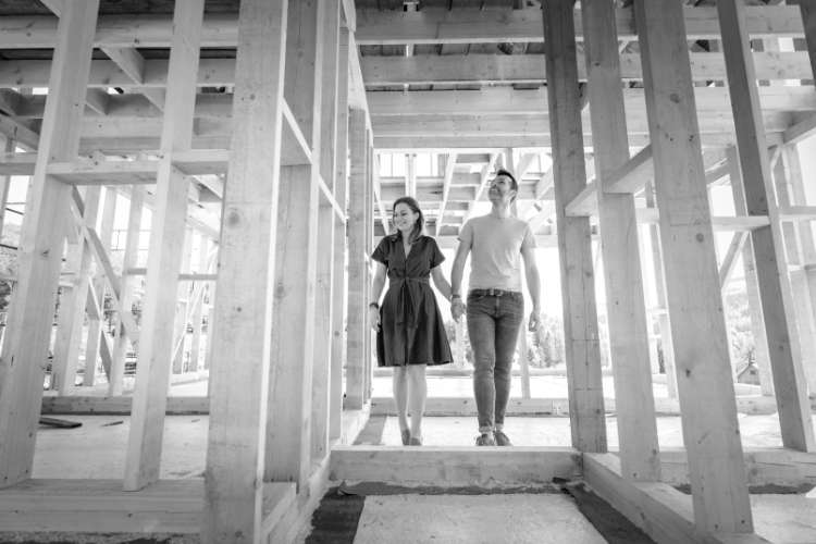 Loving couple at construction site of their new home.