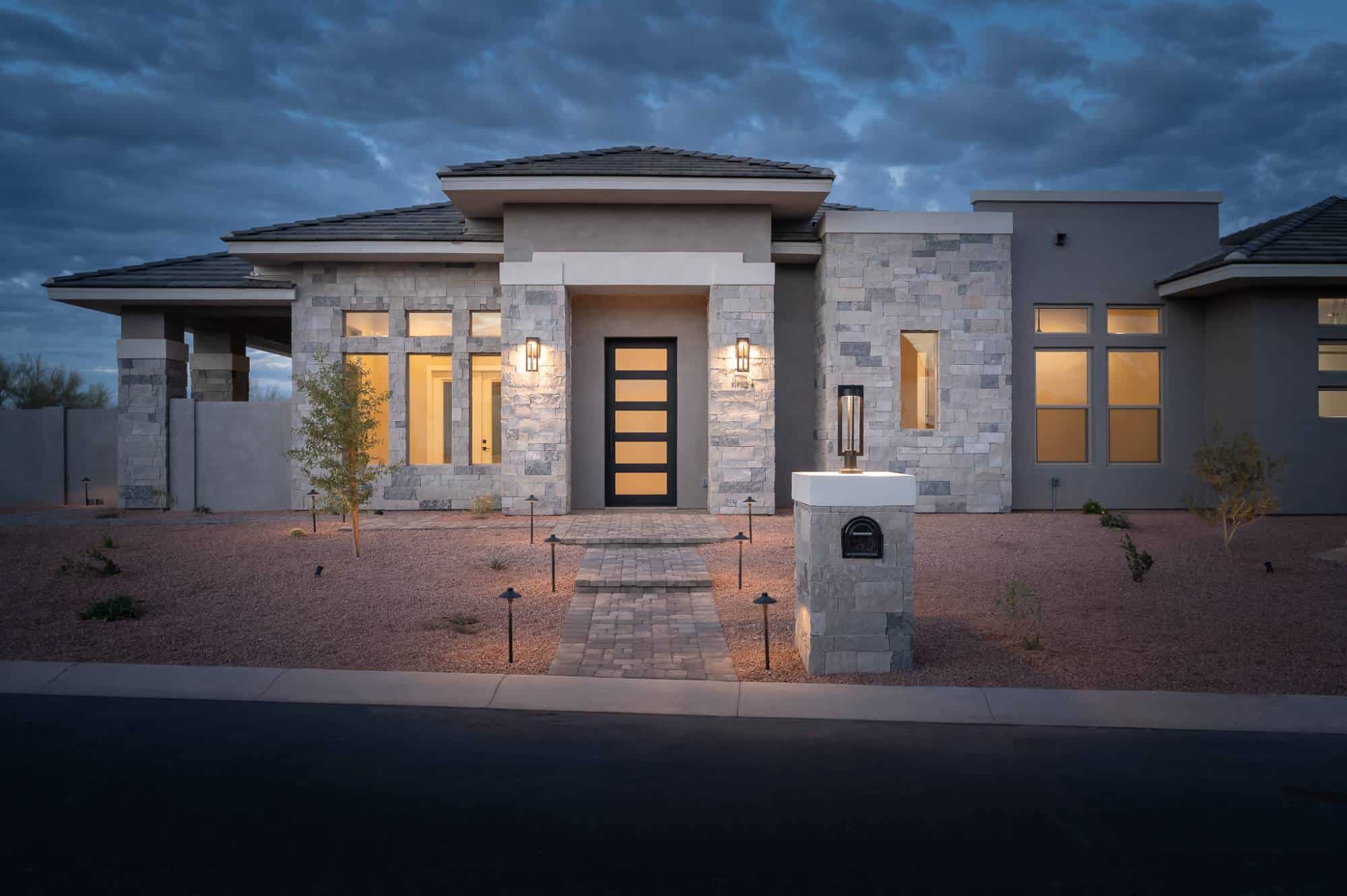 Exterior of gray stone and stucco home.