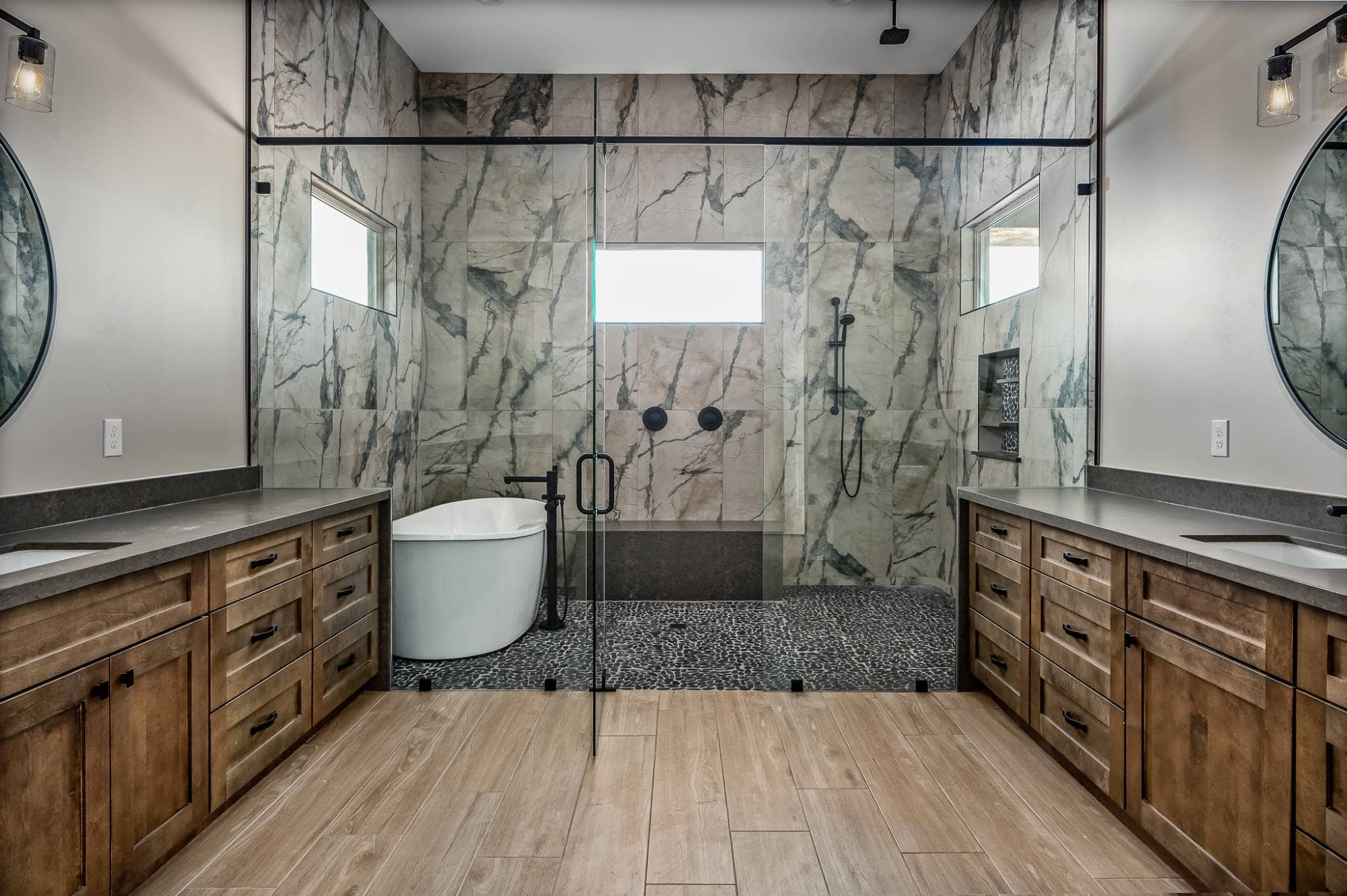 Large, modern bathroom with walk in shower that also has a soaking tub.