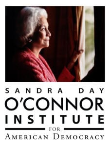 A woman with short white hair stands in profile, looking out a window with sunlight illuminating her face. She wears a red jacket. Below her is the text: "Sandra Day O'Connor Institute for American Democracy.