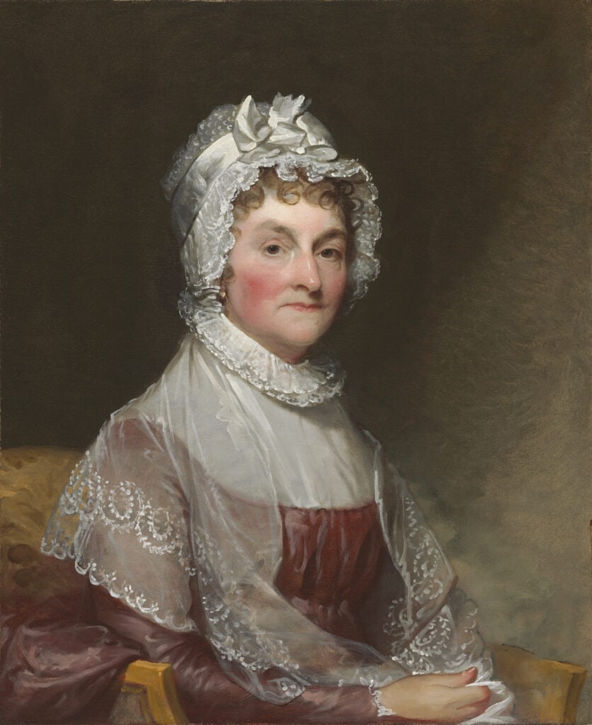 A painting of a woman wearing a white bonnet, reminiscent of historical attire often celebrated on Constitution Day.