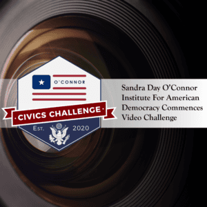A close-up of a camera lens with a logo on the left, reading "O'Connor Civics Challenge" with a ribbon and American emblem. Text on the right says "Sandra Day O’Connor Institute For American Democracy Commences Video Challenge.