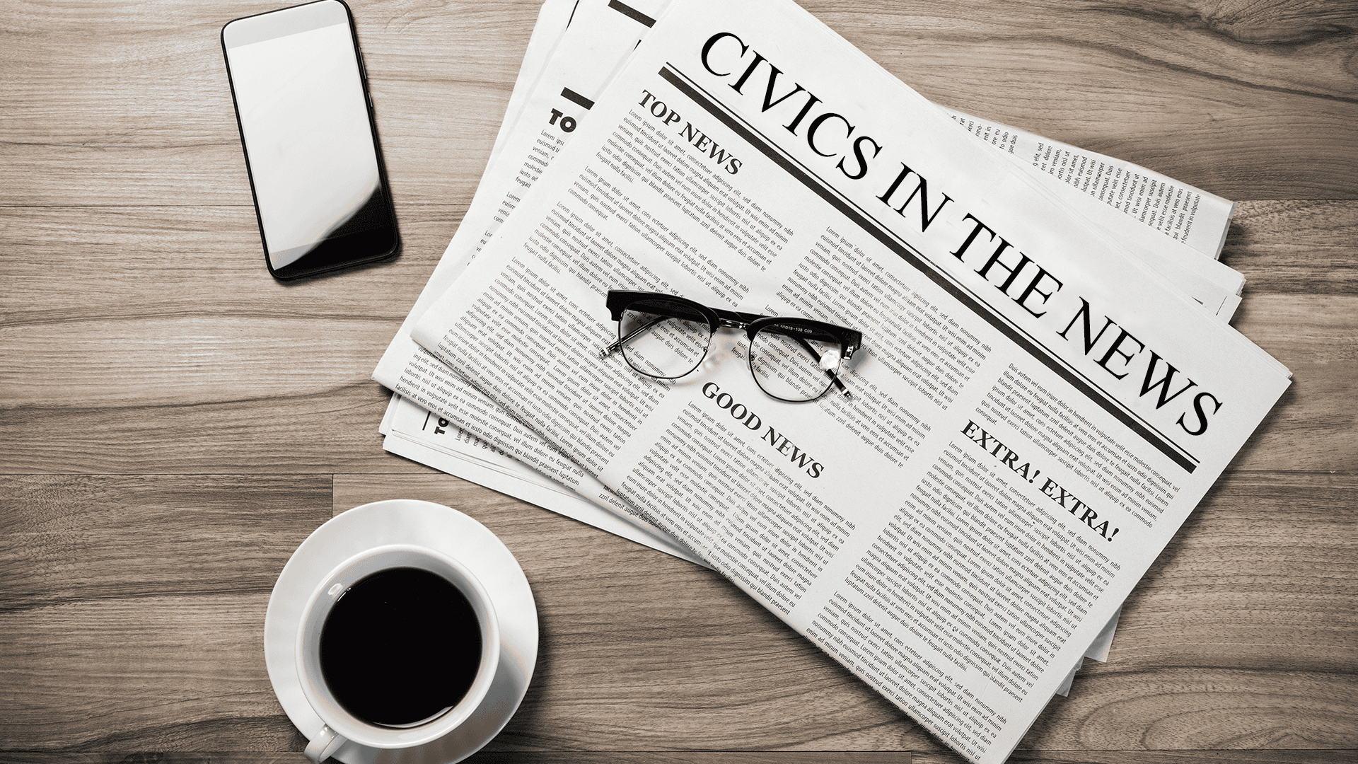 A wooden table holds a newspaper with the headline "Civics in the News," a pair of eyeglasses, a smartphone, and a cup of coffee.