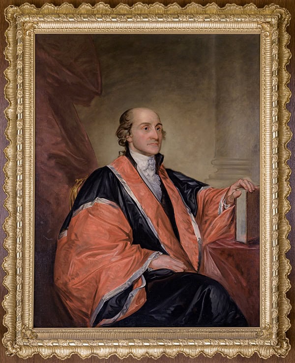 A formal oil portrait of a seated man in 18th-century attire, wearing a black and red robe, with one hand resting on a book—an elegant scene reminiscent of Constitution Day. The ornate gold frame surrounds the painting.