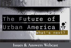 A sign reads, "The Future of Urban America: What's Next?" in bold black and white letters with artistic splatters. Below, a banner displays, "Issues & Answers Webcast" in a gray section.