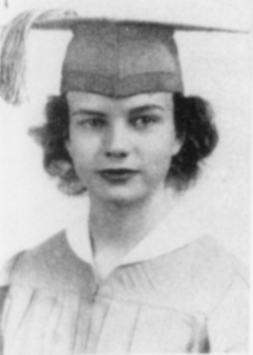Black and white portrait of a young woman in a graduation cap and gown, looking at the camera with a slight smile. She has short, wavy hair, a white collar under her gown, and an air of quiet confidence—ready to pursue justice.