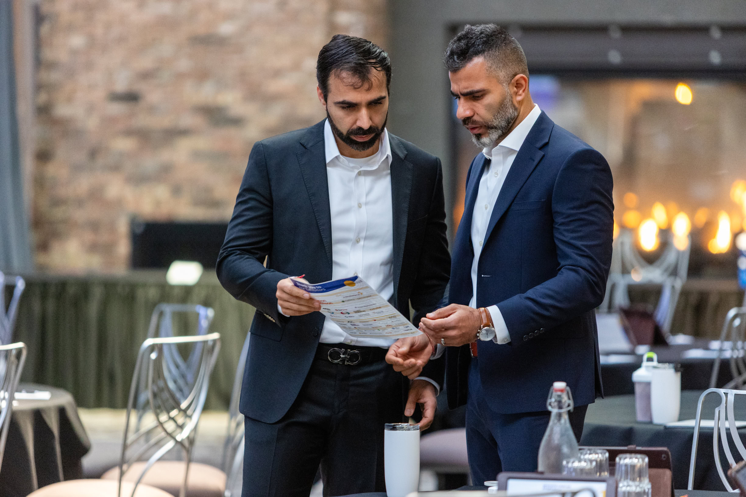Evaluation of two professionals discussing healthcare updates at an oncology conference, showcasing medical collaboration and ongoing cancer research.