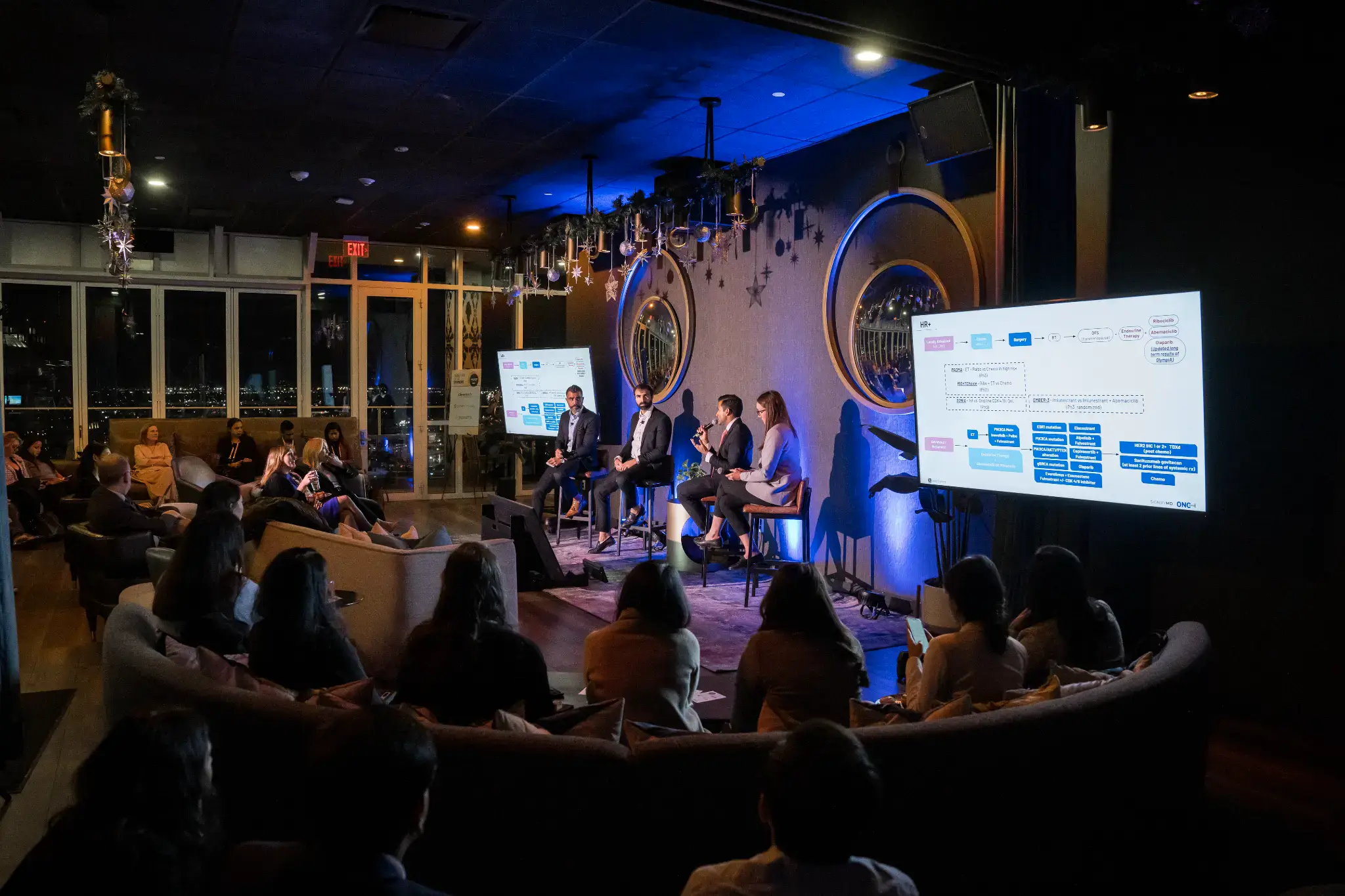 Innovative medical conference with healthcare professionals discussing oncology treatments and latest cancer research advancements in a modern venue.