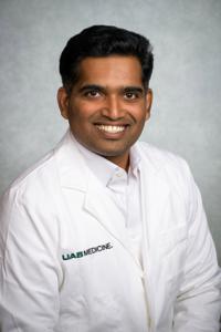 OncUpdates medical professional in white coat smiling, focus on oncology updates and healthcare expertise.