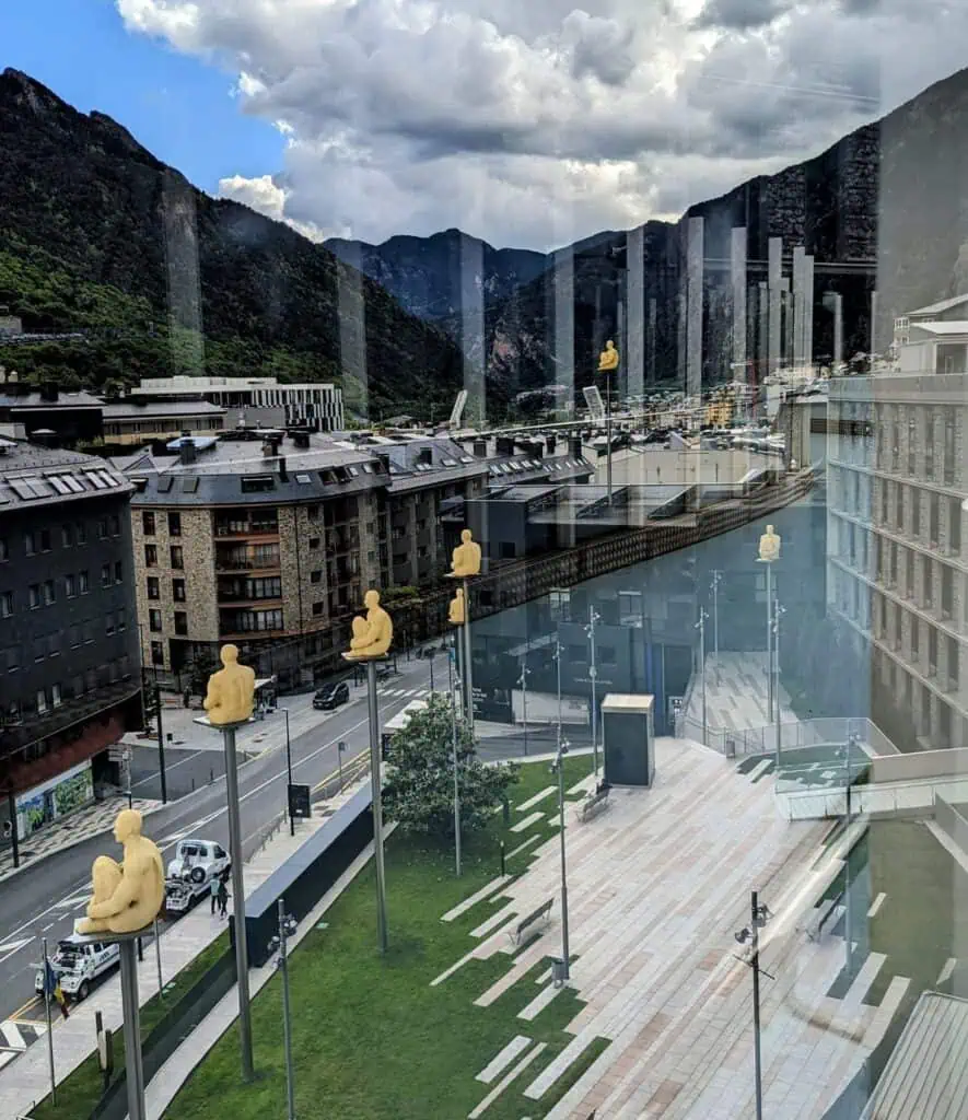 7 poets - yellow sculptures of people sitting and kneeling high up on poles in Andorra La Vella. They light up at night. This is the view from Plaça del Poble