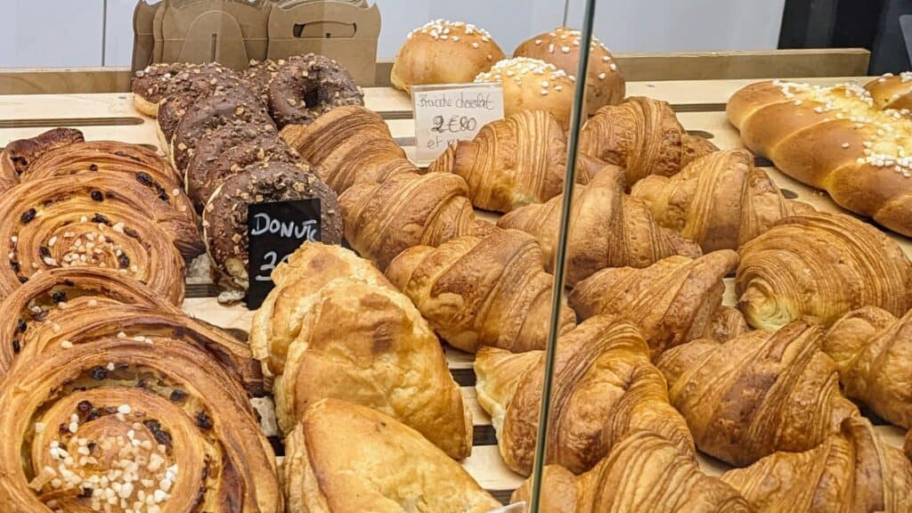 A display of breads and pastries including croissants in a bakery in St Georges square Toulouse