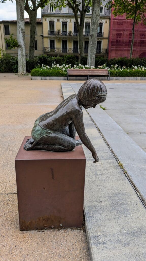 square gambetta carcassonne girl dipping her hand in a pool
