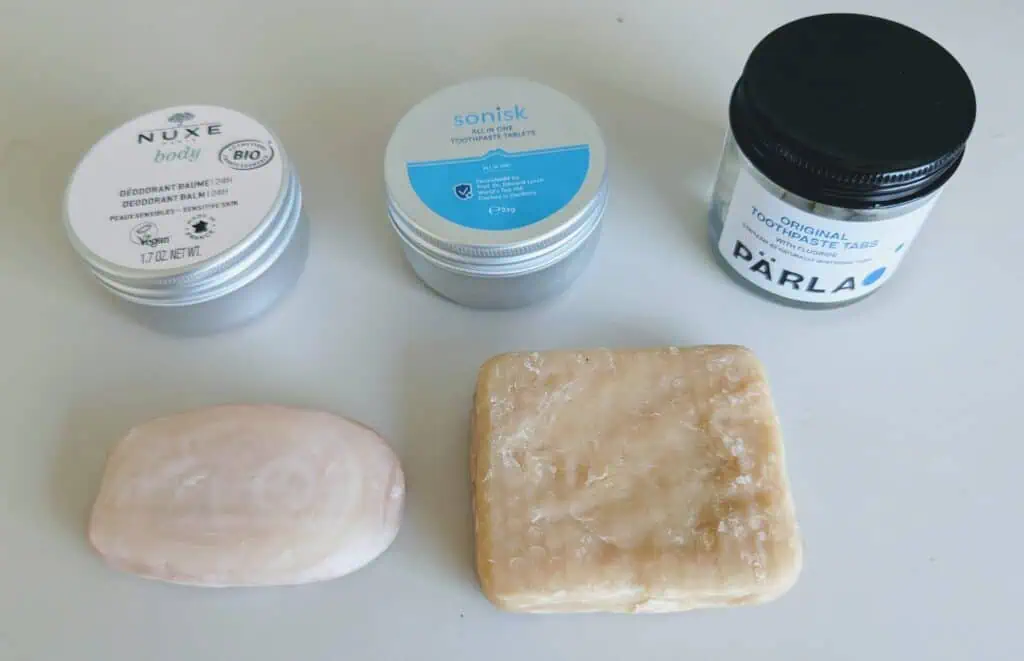 Solid, liquid-free toiletries ideal for carry-on travel — includes toothpaste tablets, deodorant balm, and soap bars, all airport security-friendly.