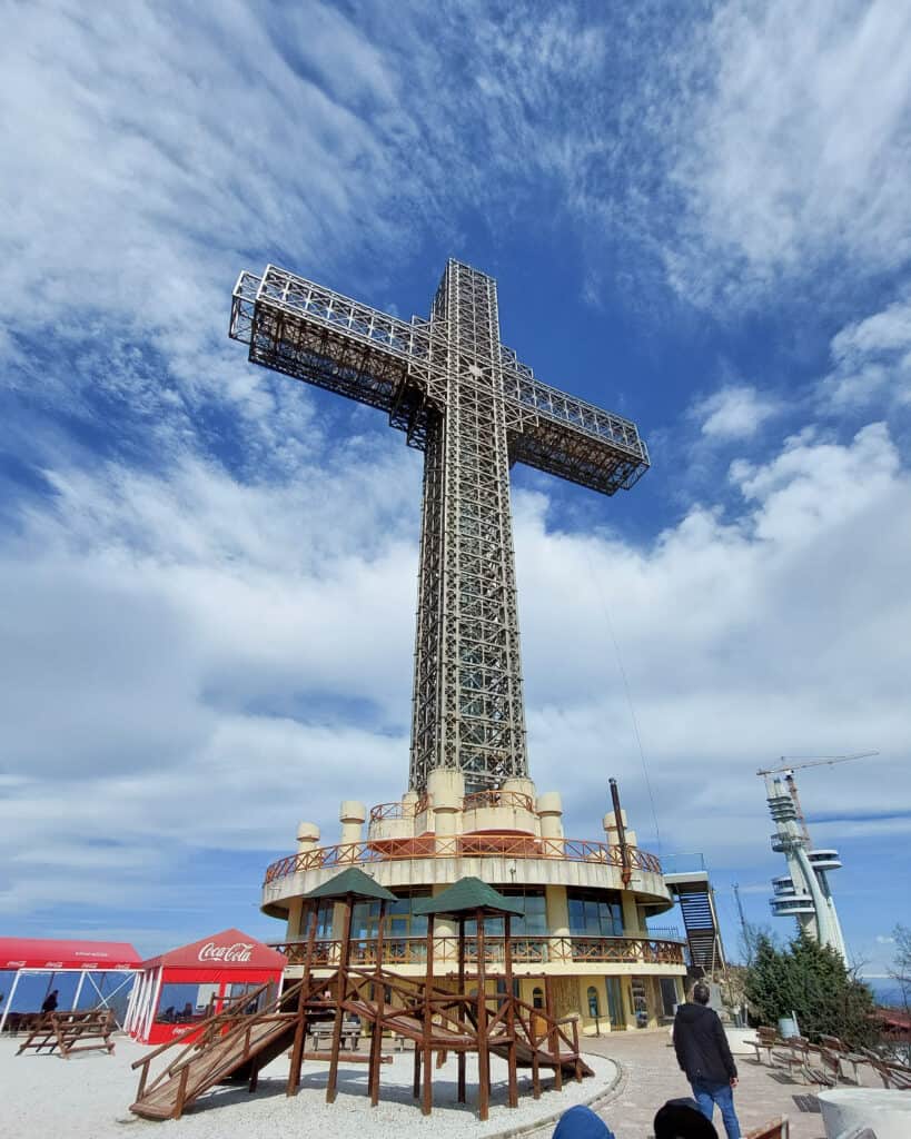 millennium cross at top with play area plus cafe and shop built into the base