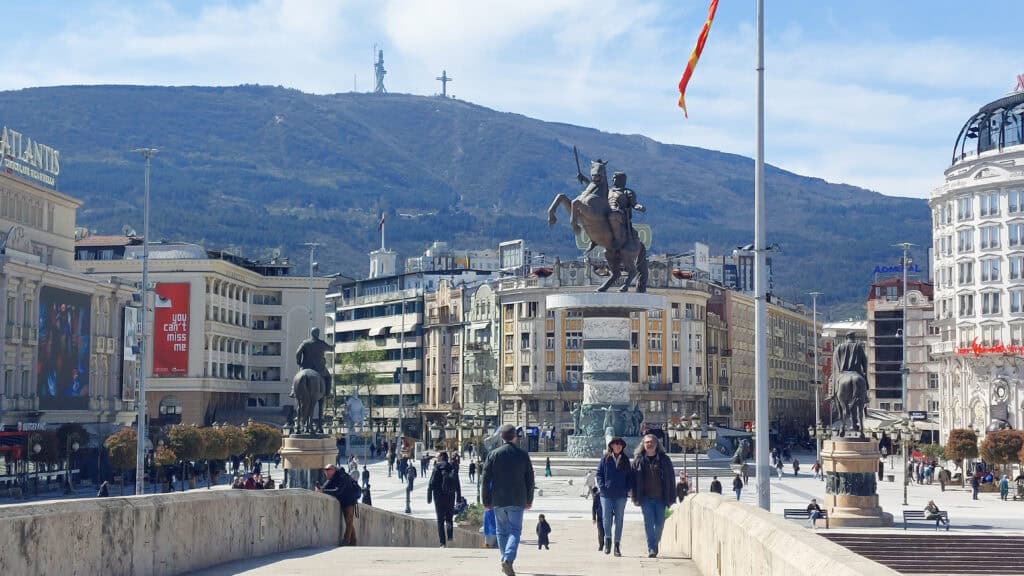 Macedonia Square and the Warrior Statue in the centre of Skopje, the capital of North Macedonia. Mount Vodno and the Millennium Cross are visible in the background.