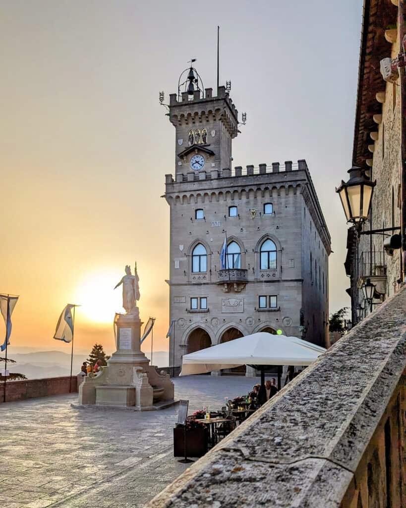 Palazzo Pubblico with Statue of Liberty in front at sunset