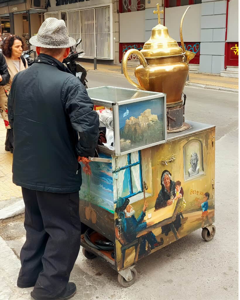 traditional coffee street vendor with customised cart and big brass coffee pot
