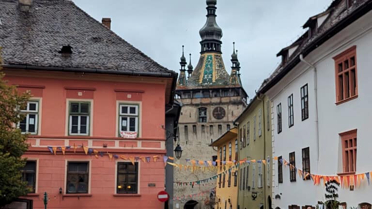 view of clock tower and vlads house in yellow Sighisoara