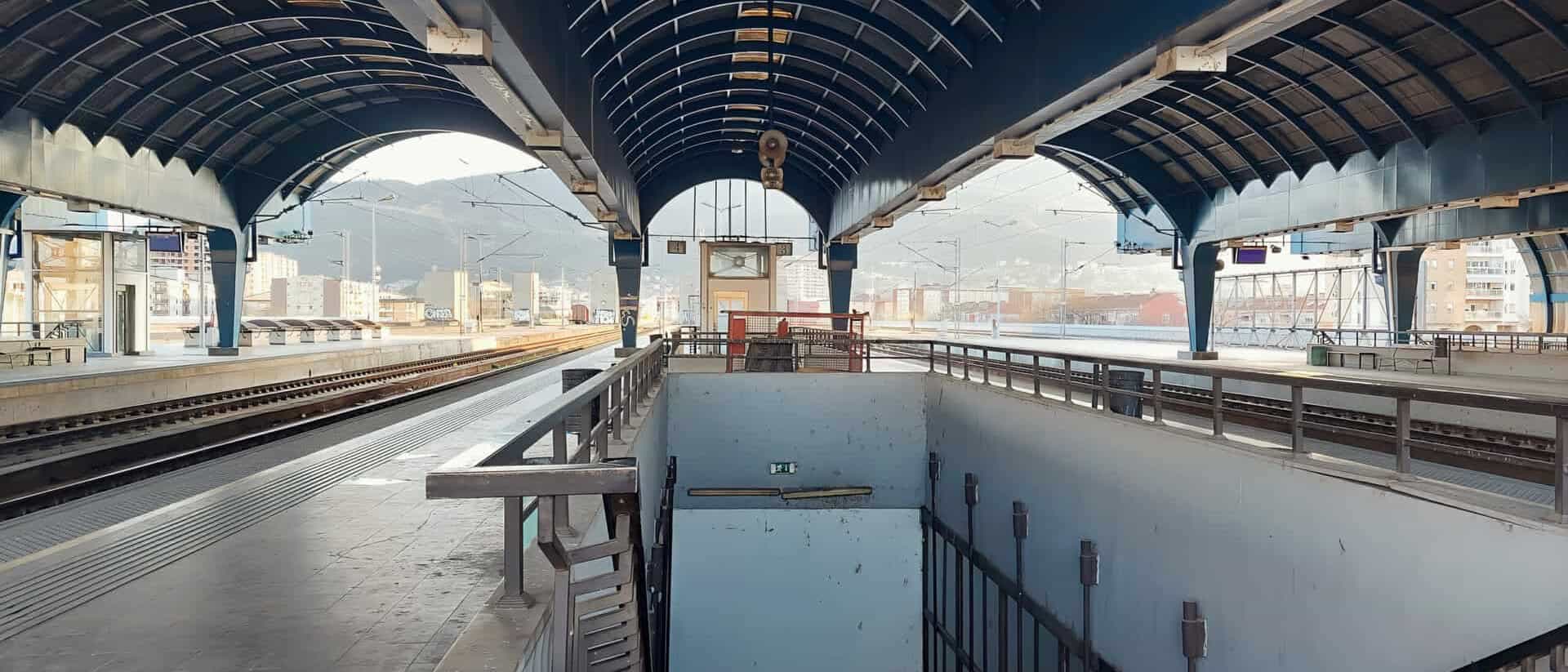 Empty Skopje train station platform view out to the city and mount vodno
