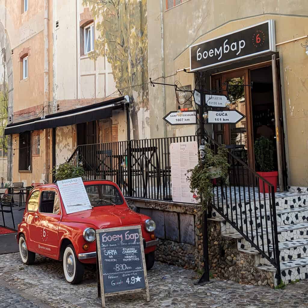 Skadarlija street in Belgrade - Boem Bar and Brasserie with red Zastava 750 car outside
