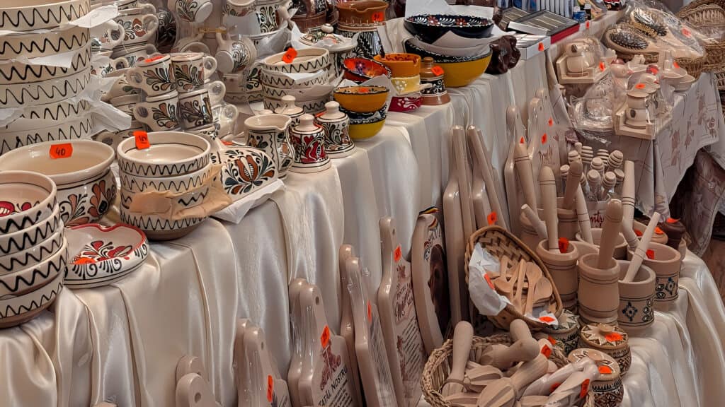 traditional crafts in Sighisoara - painted pottery, carved wooden items including chopping boards