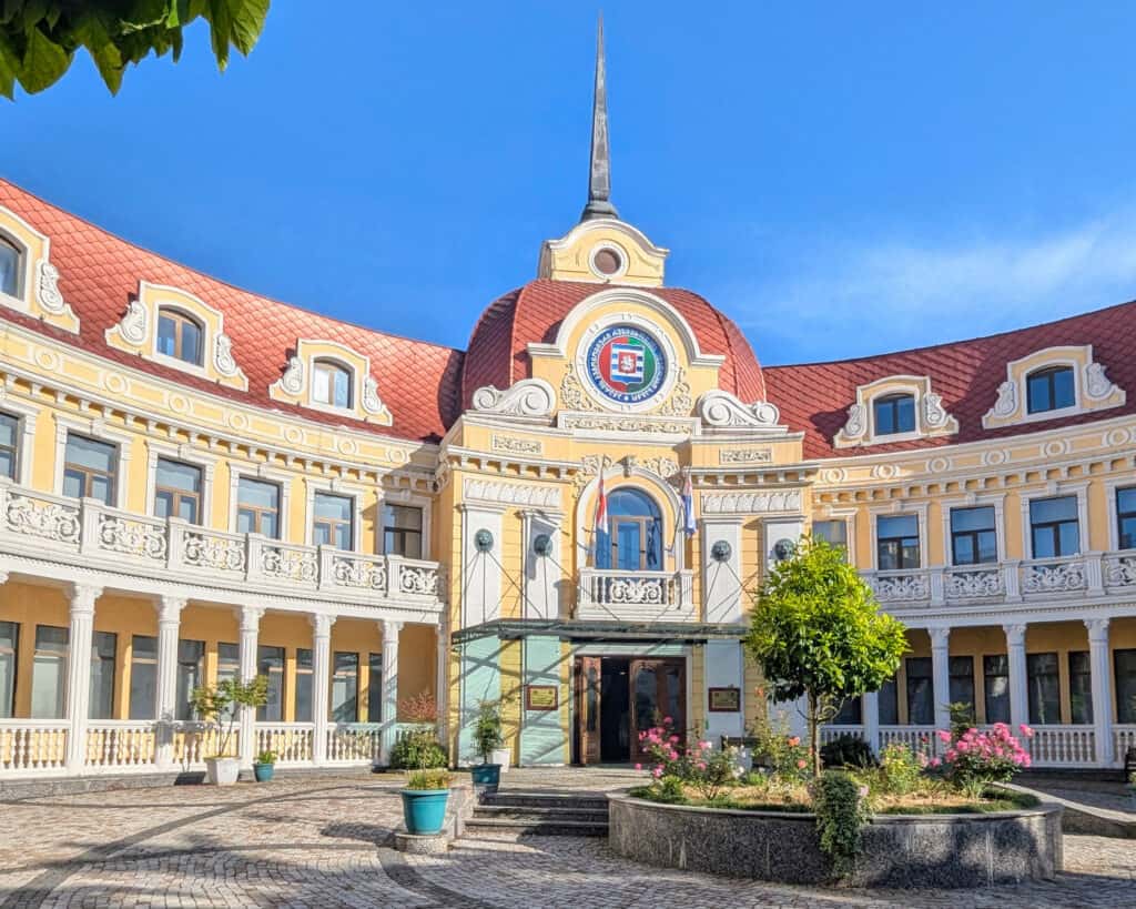 Butami Teaching Art University - yellow and white neo classical building with red roof