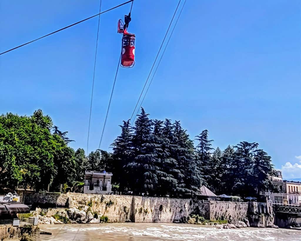 Red cable car over the river Kutaisi