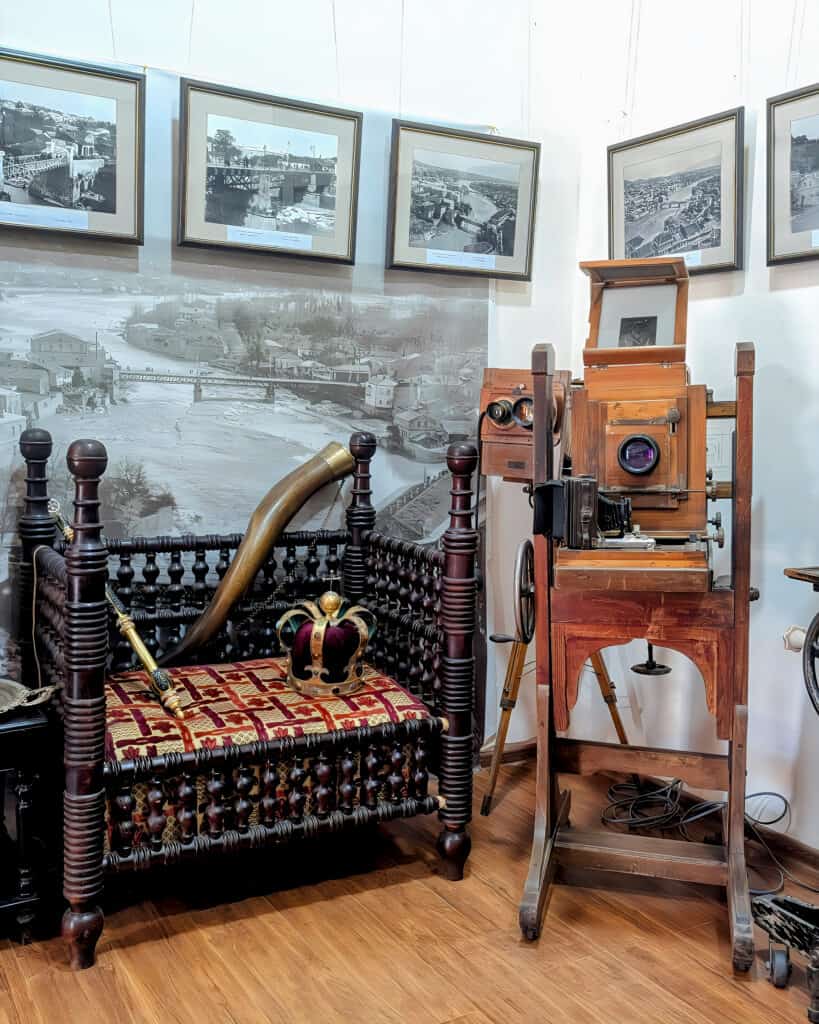 exhibits in the David Mkheidze Photo-Cinema Chronicle Museum in Kutaisi Georgia seat with a crown and old camera