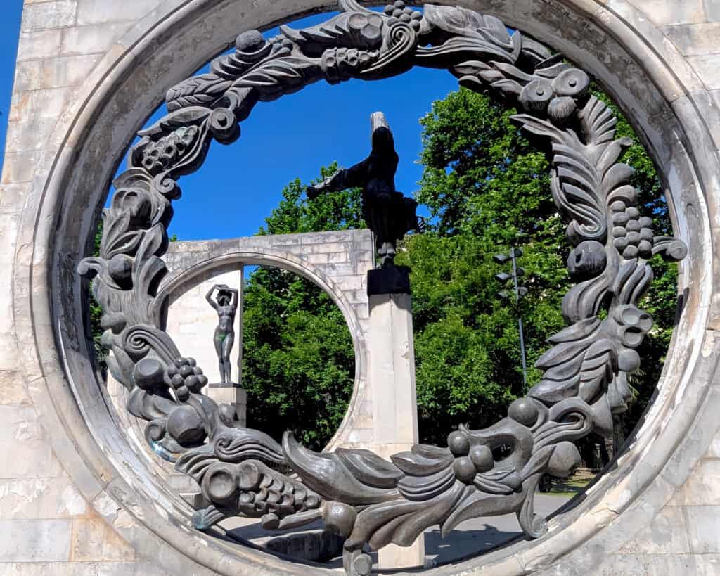 monument at Kutaisi's Soviet Sculpture Complex. A series of rectangular blocks with circles, carvings and figures