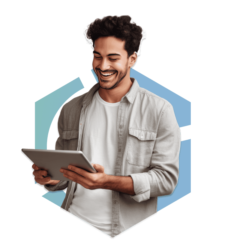 Happy young man using tablet with a smile, modern casual style, indoor setting.