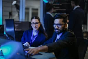 Professional cybersecurity team working on computers in a high-tech environment.