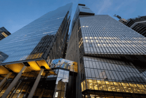 Skyscraper buildings with glass facades reflecting the sky and cityscape.