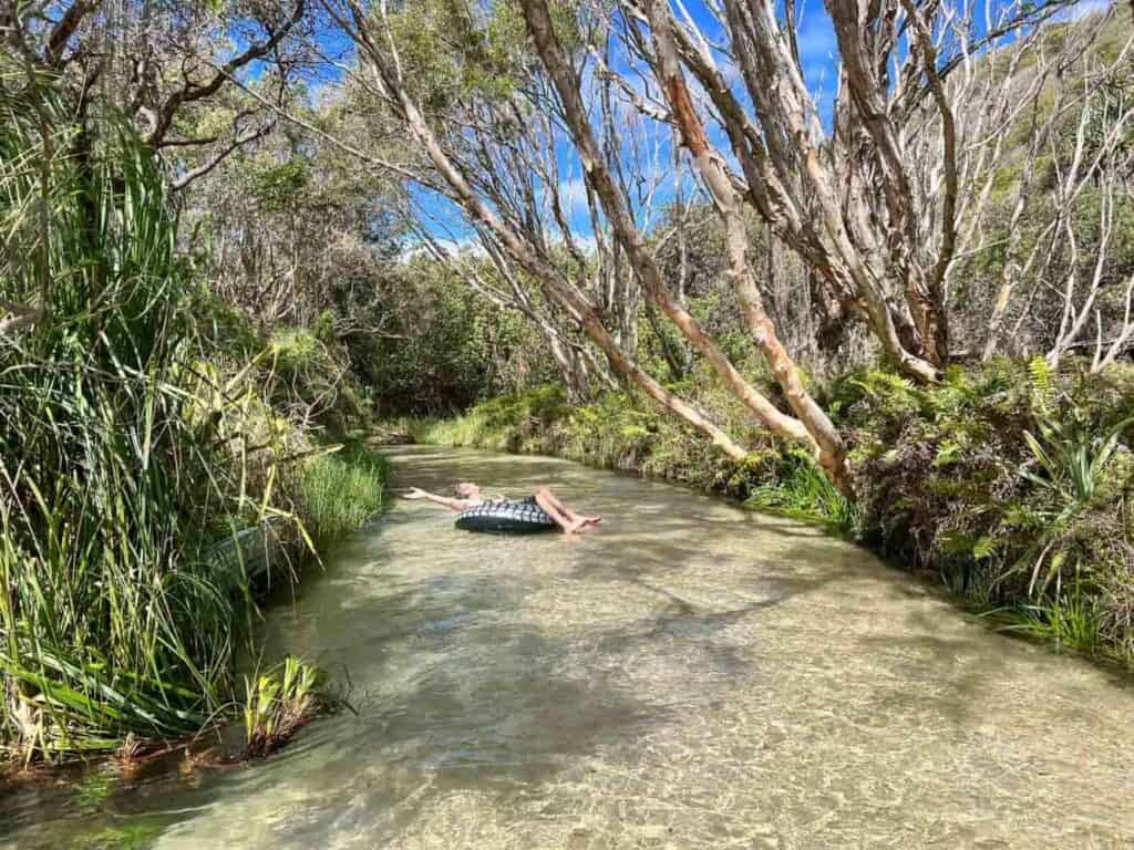 Person floating on inflatable in Fraser Island river.