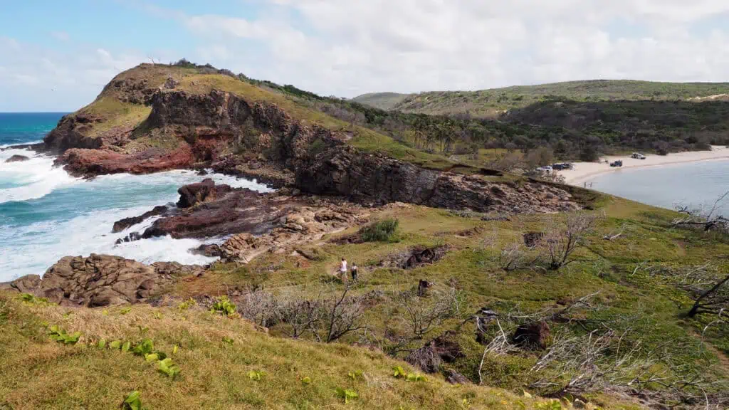 Scenic Fraser Island beach with cliffs and ocean views.