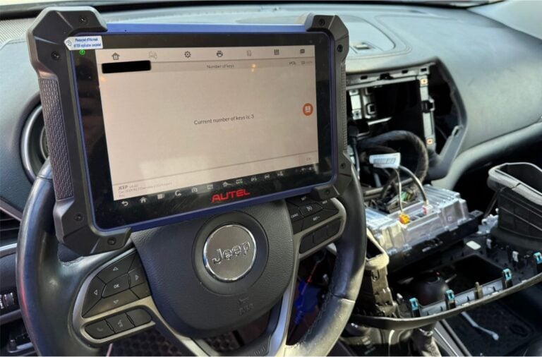 Automotive locksmith programming new smart fob for a 2019 Jeep through a secure gateway with specialized programmer. All keys lost