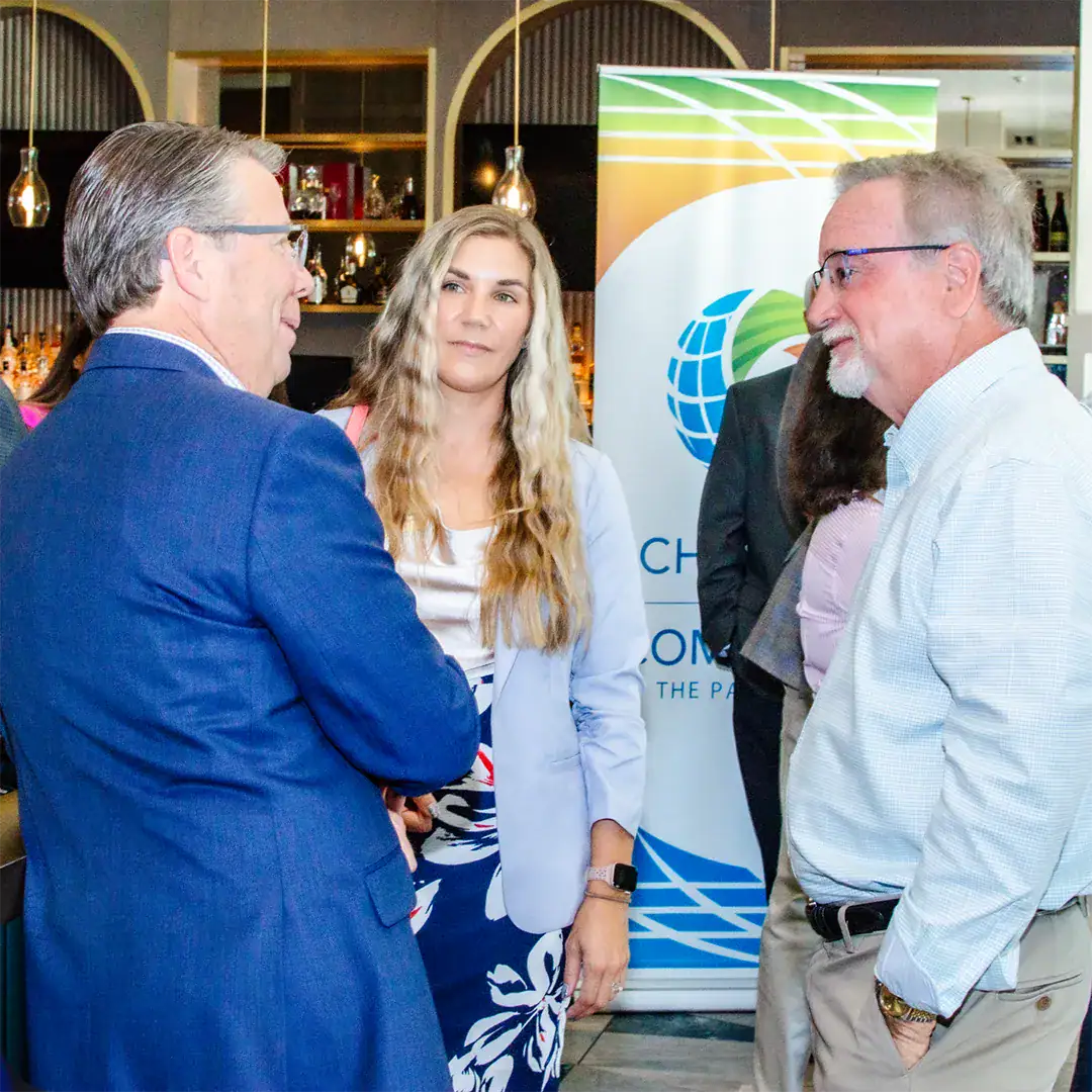 Several professionals are having a conversation at a networking event.