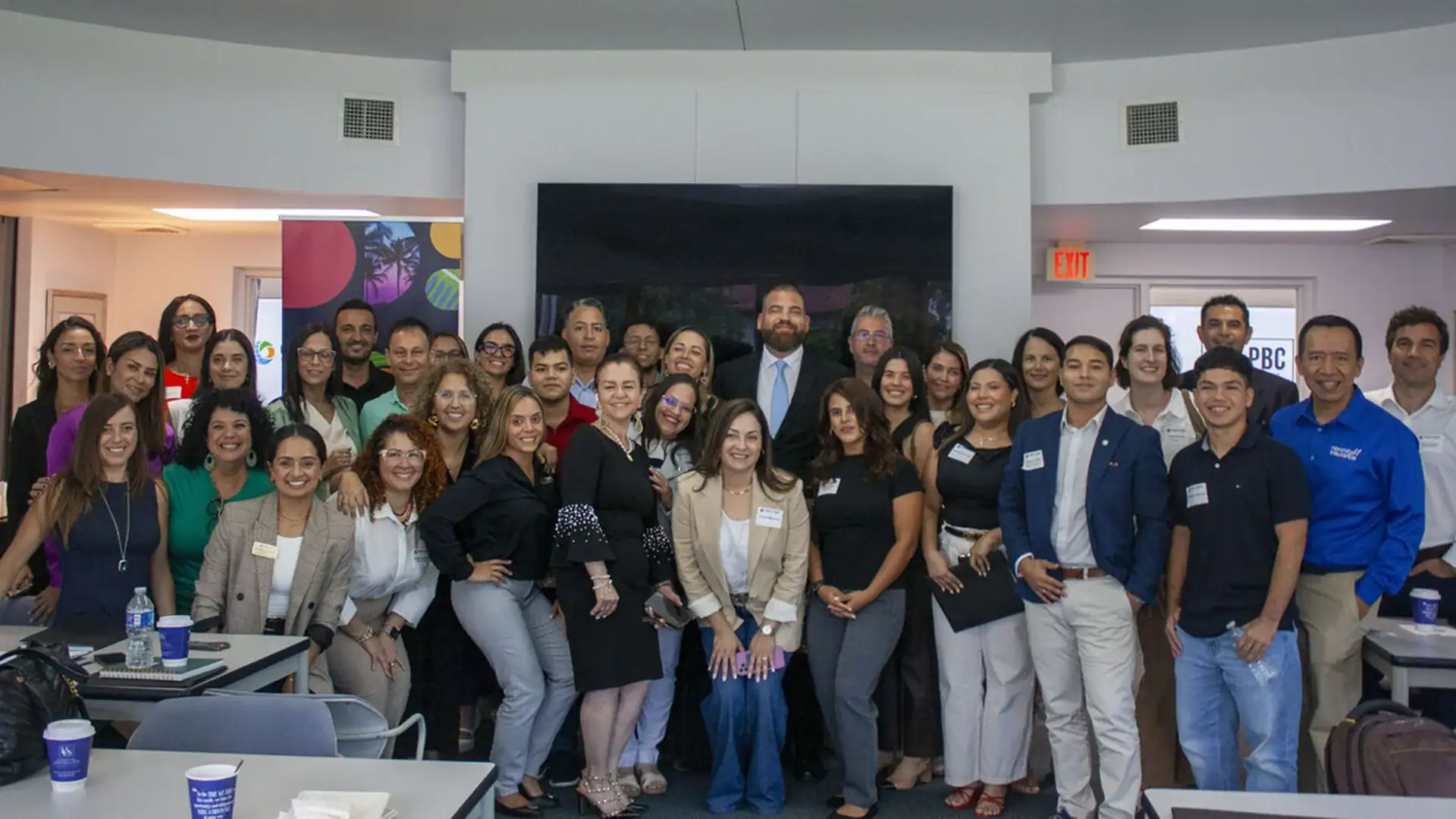 People smiling and posing for a group photo at a professional event.