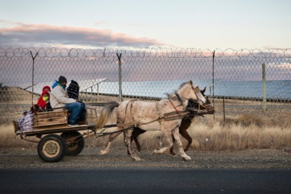DE AAR, EMTHANJENI - 27 August 2021 - A horse cart carrying locals pass Globeleq's solar farm.
Photo: Bram Lammers