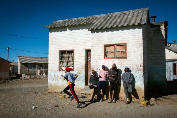 DE AAR, EMTHANJENI - 28 August 2021 - Youngsters hang in front of a house in a township near De Aar
Photo: Bram Lammers