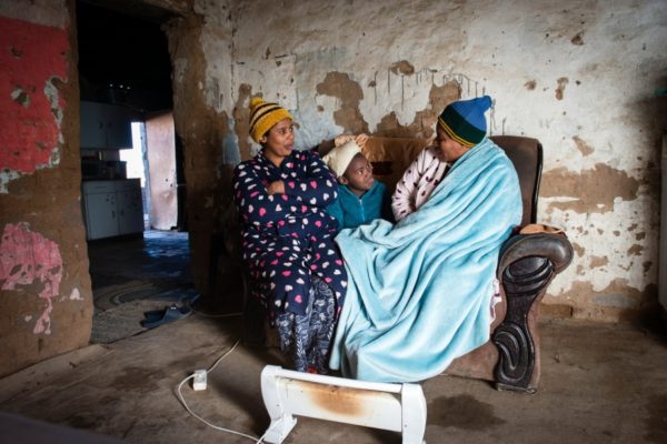DE AAR, EMTHANJENI - 28 August 2021 - A family in a township near De Aar keep warm with a blanket and electric heater.
Photo: Bram Lammers