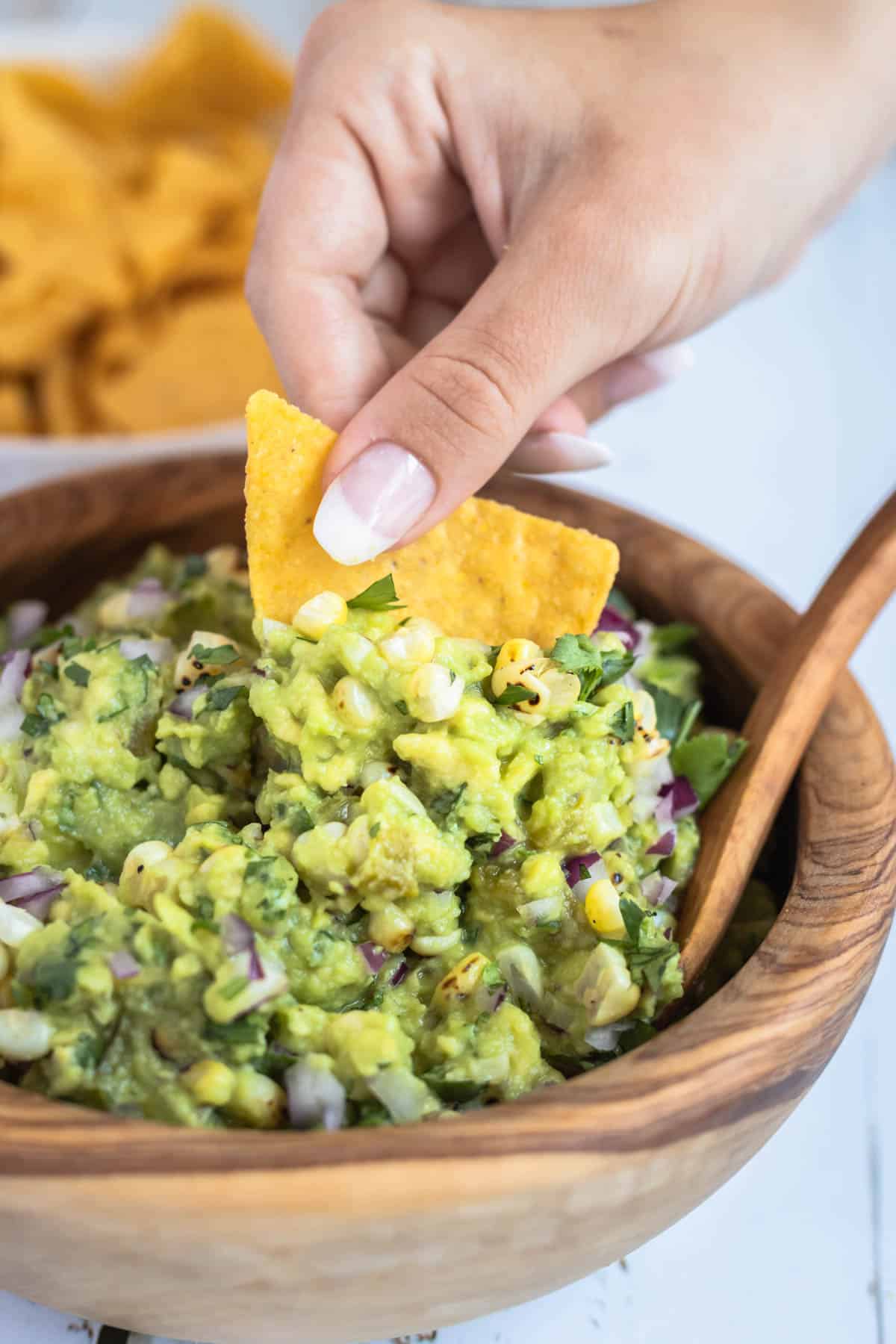 picture of a chip being dipped in guacamole