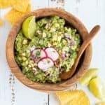 picture of a bowl of guacamole surrounded by tortilla chips