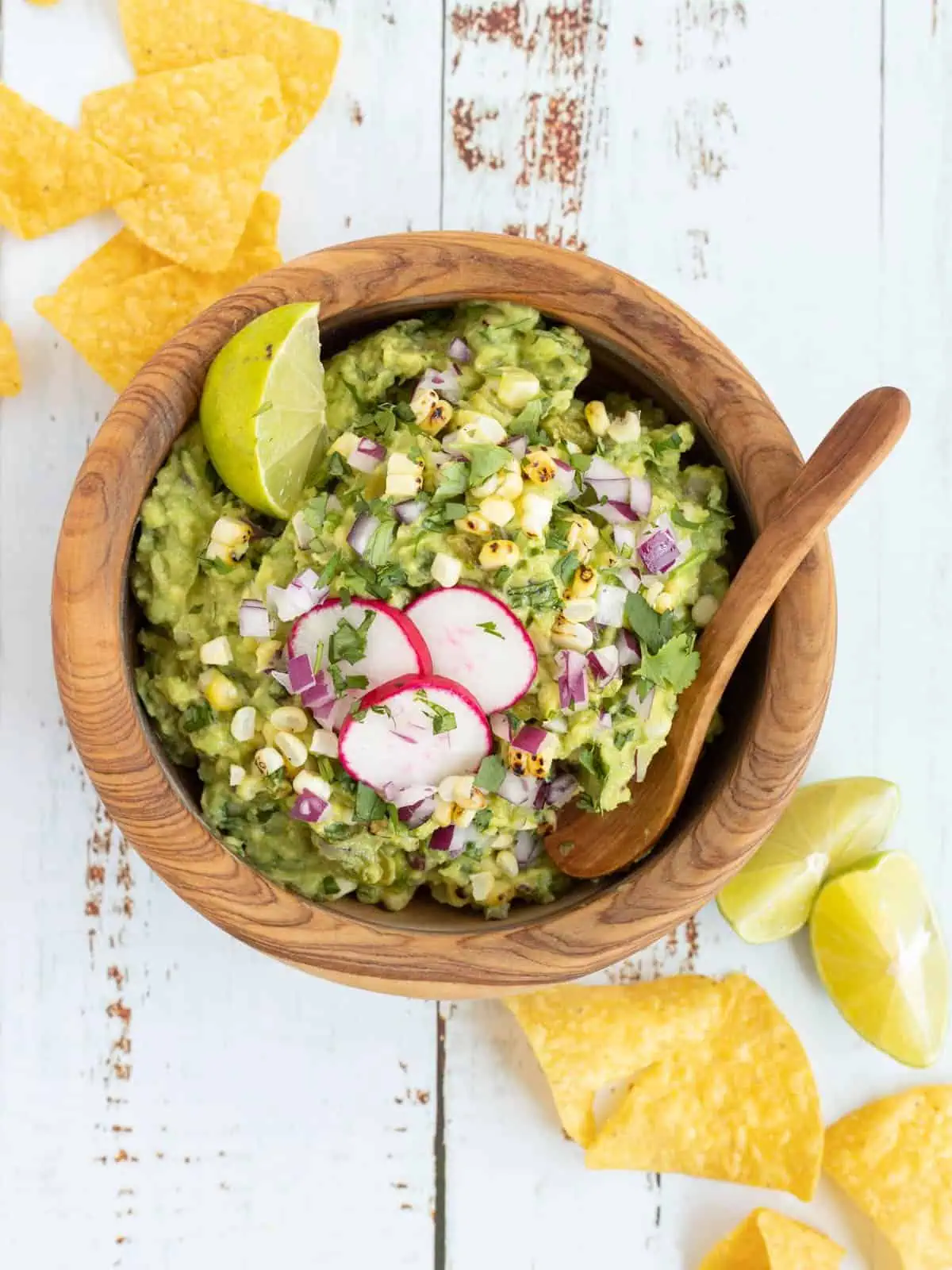 picture of a bowl of guacamole surrounded by tortilla chips